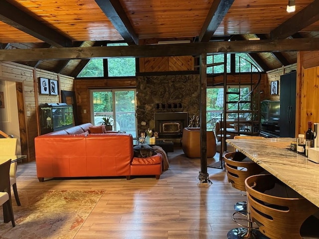 52 Nourse St, Westborough, MA 01581 - living room with healthy amount of natural light, wood ceiling, wood-type flooring, wood walls, and a wood stove