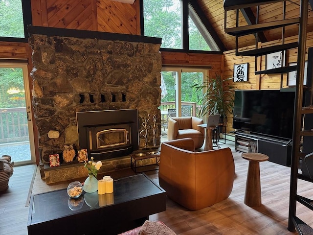 52 Nourse St, Westborough, MA 01581 - living area featuring wood finished floors, wooden walls, a stone fireplace, a wooden ceiling with exposed beams, and high vaulted ceiling
