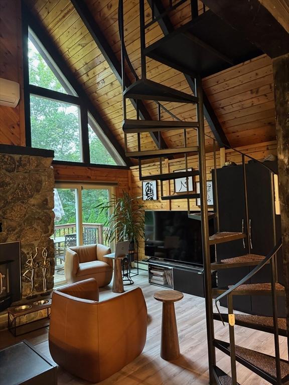 52 Nourse St, Westborough, MA 01581 - living area featuring a wooden ceiling with exposed beams, an AC wall unit, hardwood / wood-style flooring, high vaulted ceiling, and wooden walls