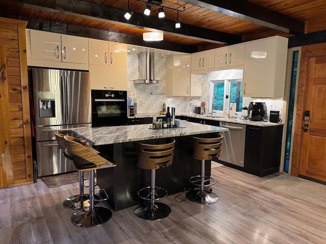 52 Nourse St, Westborough, MA 01581 - kitchen featuring appliances with stainless steel finishes, wall chimney exhaust hood, a wood ceiling with exposed beams, white cabinets, and decorative backsplash