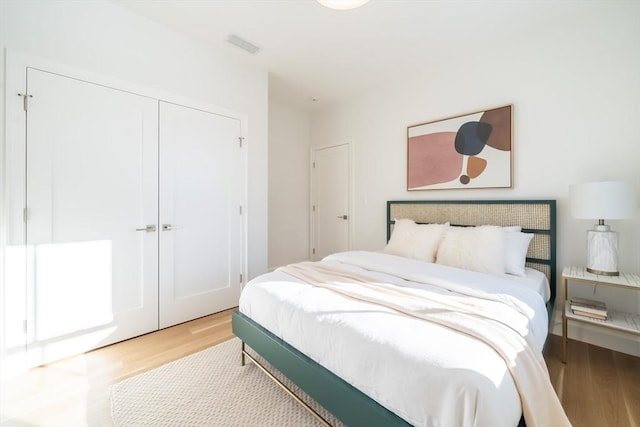 bedroom featuring a closet and light hardwood / wood-style flooring