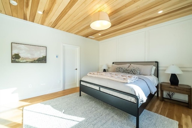 bedroom featuring wood ceiling and wood-type flooring