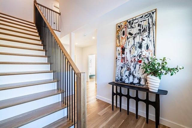 stairs featuring wood-type flooring