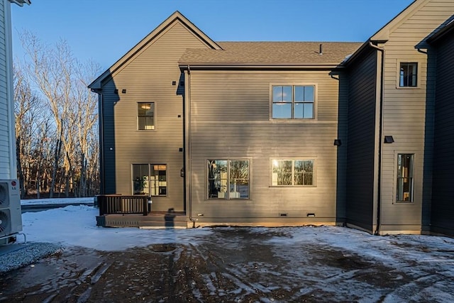 view of snow covered rear of property