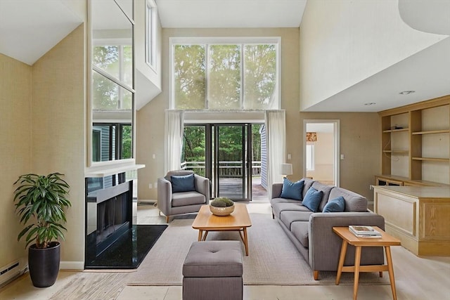 2 Hillside Dr Unit 2, Wayland, MA 01778 - living area with a towering ceiling, a fireplace, baseboard heating, and wood finished floors