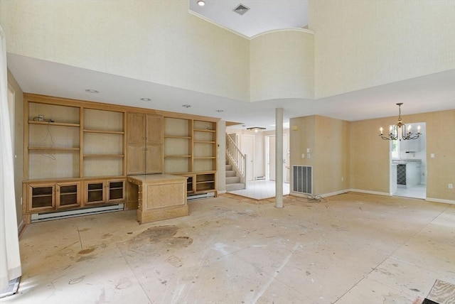 2 Hillside Dr Unit 2, Wayland, MA 01778 - unfurnished living room with a towering ceiling, stairway, and a chandelier