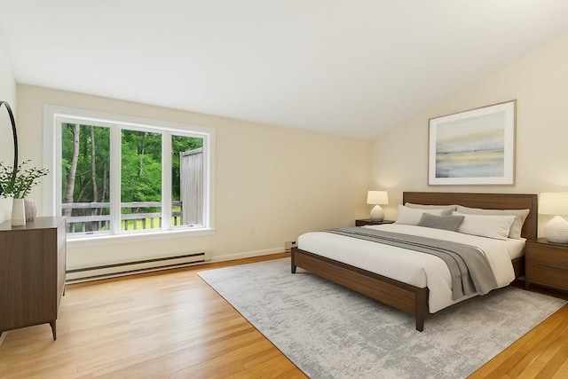 2 Hillside Dr Unit 2, Wayland, MA 01778 - bedroom with a baseboard radiator, light wood-style floors, and vaulted ceiling
