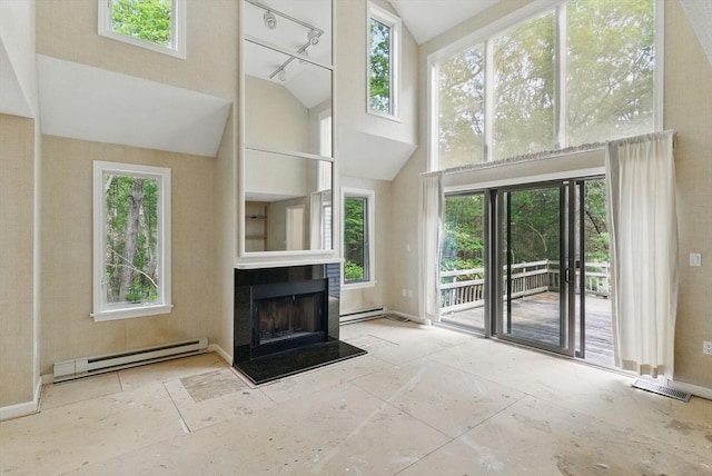 2 Hillside Dr Unit 2, Wayland, MA 01778 - unfurnished living room featuring a baseboard radiator, high vaulted ceiling, plenty of natural light, and a fireplace with raised hearth