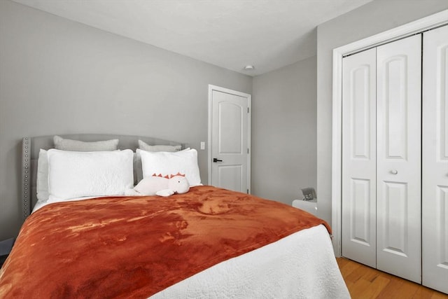 bedroom with a closet and light hardwood / wood-style flooring