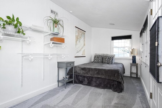 carpeted bedroom with vaulted ceiling and baseboards