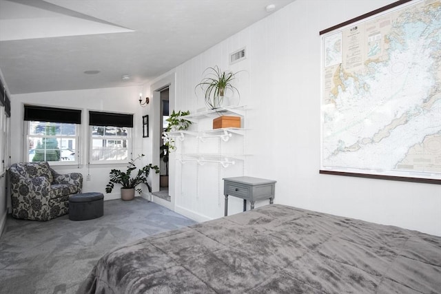 bedroom with lofted ceiling, visible vents, and carpet flooring