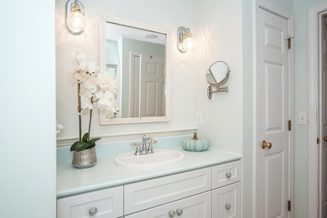 bathroom with a closet and vanity