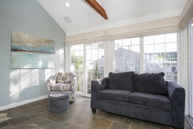 sunroom / solarium featuring lofted ceiling with beams