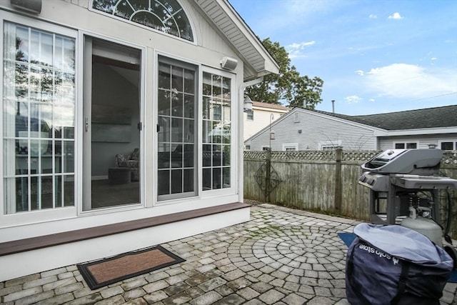 view of patio with fence and area for grilling