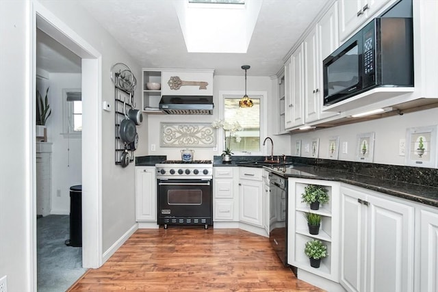 kitchen with decorative light fixtures, open shelves, white cabinetry, a sink, and black appliances