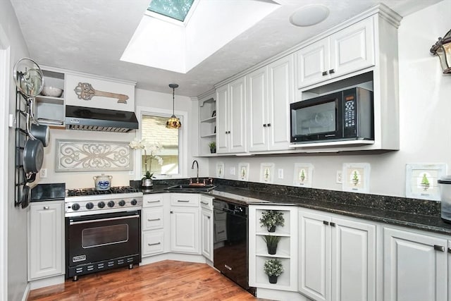 kitchen with a skylight, open shelves, white cabinets, black appliances, and extractor fan