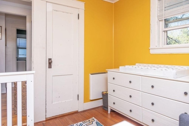 interior space with baseboards, radiator, and light wood-style floors