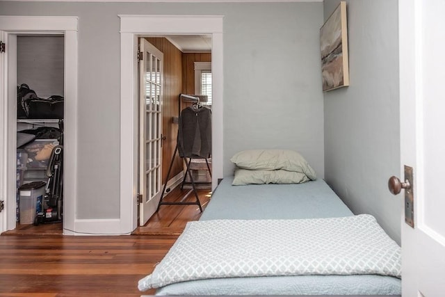 bedroom featuring french doors and wood finished floors