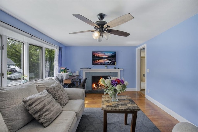 298 Oakland Rd, Barnstable, MA 02601 - living area with ceiling fan, a brick fireplace, wood finished floors, and baseboards