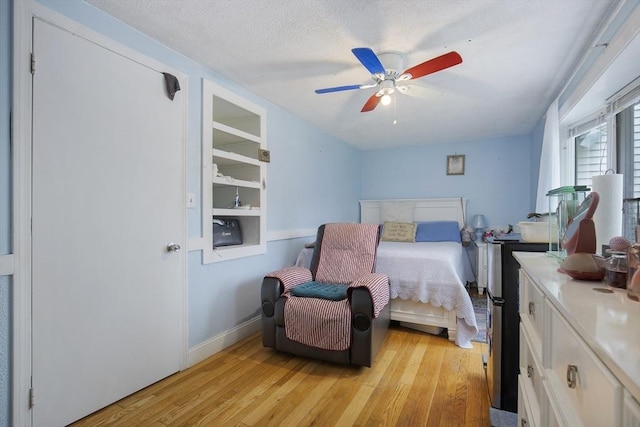 298 Oakland Rd, Barnstable, MA 02601 - bedroom featuring light wood-type flooring, baseboards, ceiling fan, and a textured ceiling