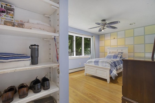 298 Oakland Rd, Barnstable, MA 02601 - bedroom featuring baseboard heating, light wood-type flooring, and ceiling fan