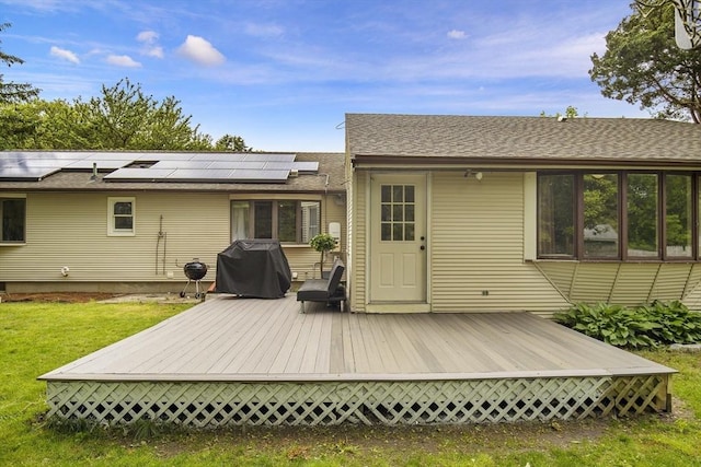 298 Oakland Rd, Barnstable, MA 02601 - back of property with solar panels, a wooden deck, a yard, and a shingled roof