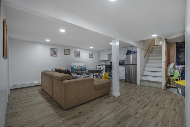 298 Oakland Rd, Barnstable, MA 02601 - living room with wood finished floors, stairs, recessed lighting, and a baseboard radiator