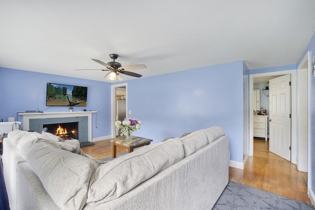 298 Oakland Rd, Barnstable, MA 02601 - living area featuring light wood-style flooring, ceiling fan, baseboards, and a fireplace