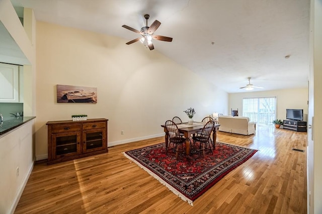 dining area with ceiling fan and light wood-type flooring