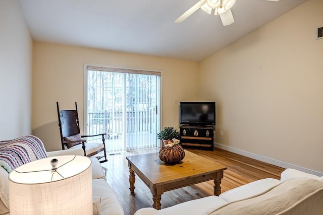 living room with ceiling fan, wood-type flooring, and lofted ceiling