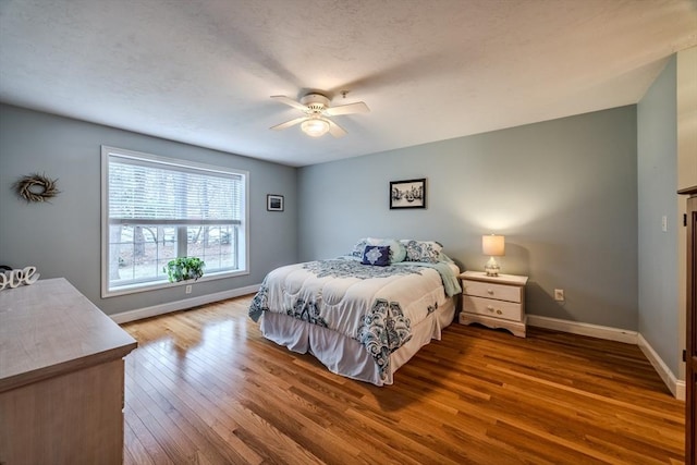 bedroom featuring hardwood / wood-style floors and ceiling fan