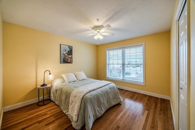 bedroom with a closet, ceiling fan, and hardwood / wood-style floors