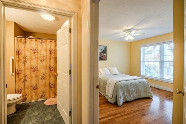 bedroom featuring ceiling fan and dark wood-type flooring