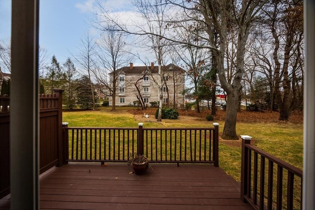 wooden terrace with a lawn