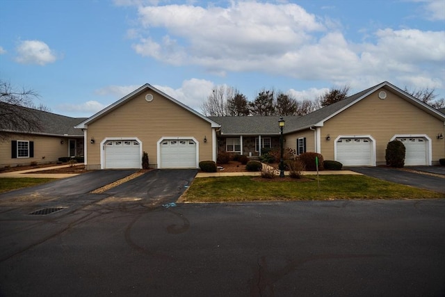 single story home with a garage and a front yard