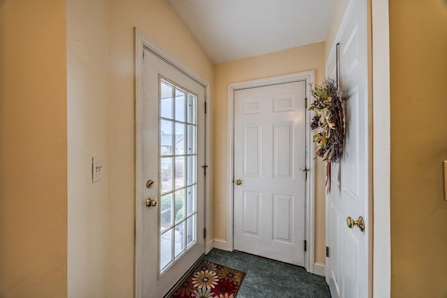 doorway with vaulted ceiling and a wealth of natural light