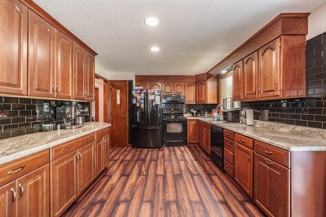 896 Montgomery St, Chicopee, MA 01013 - kitchen with black appliances, backsplash, a sink, dark wood-style floors, and brown cabinets
