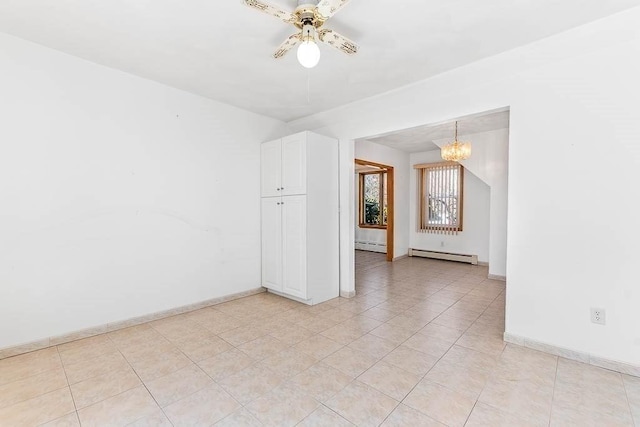 empty room featuring ceiling fan with notable chandelier, baseboards, a baseboard heating unit, and light tile patterned flooring