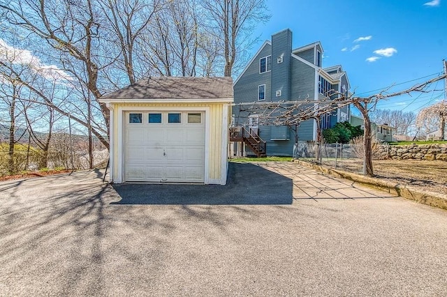 detached garage featuring aphalt driveway