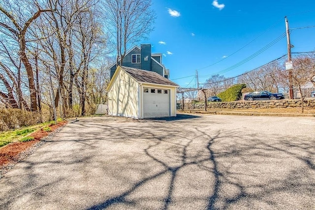 detached garage with aphalt driveway