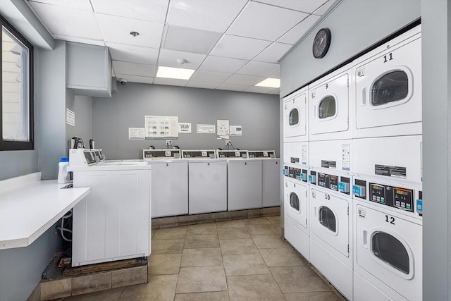 laundry area with washer and clothes dryer, light tile patterned flooring, and stacked washer / dryer