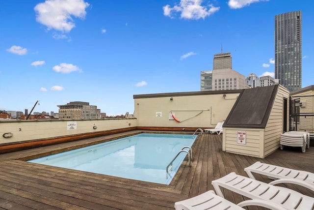 view of swimming pool featuring a wooden deck