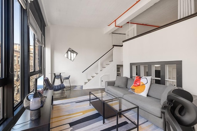 living room featuring light hardwood / wood-style floors and a high ceiling