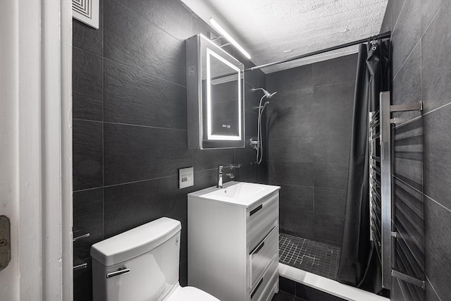 bathroom with a shower with curtain, vanity, tile walls, and toilet