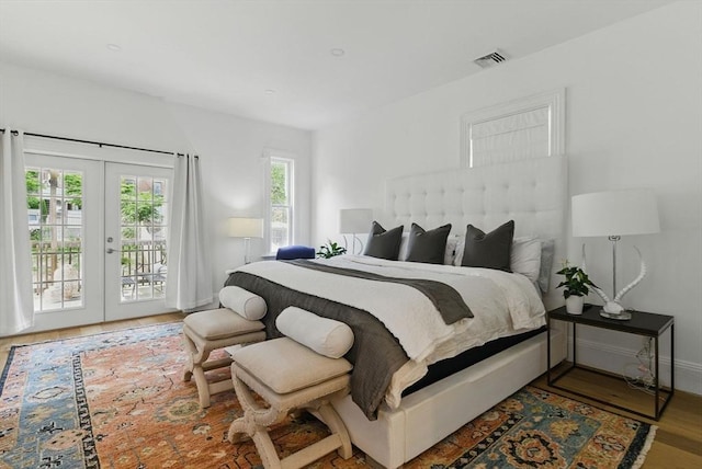 782 E 4th St, Boston, MA 02127 - bedroom featuring access to exterior, multiple windows, french doors, and wood finished floors