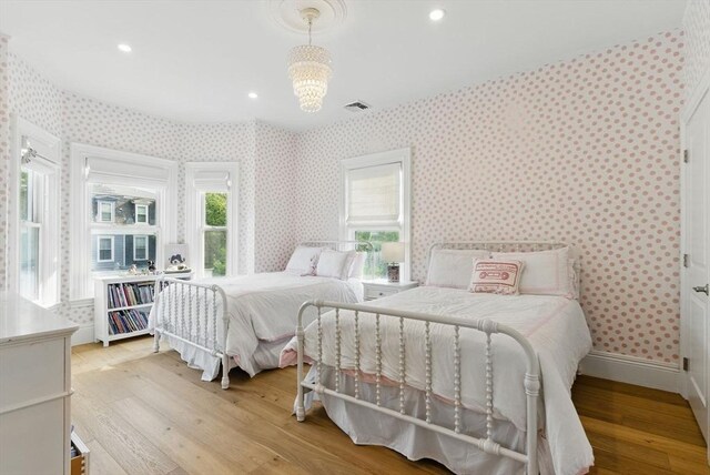 782 E 4th St, Boston, MA 02127 - bedroom featuring light wood-style flooring, wallpapered walls, a chandelier, recessed lighting, and baseboards