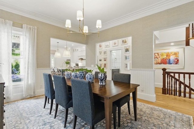 782 E 4th St, Boston, MA 02127 - dining space featuring wood finished floors, wainscoting, ornamental molding, a chandelier, and wallpapered walls