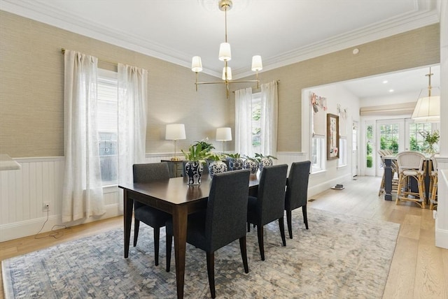 782 E 4th St, Boston, MA 02127 - dining space featuring wallpapered walls, light wood finished floors, crown molding, and wainscoting