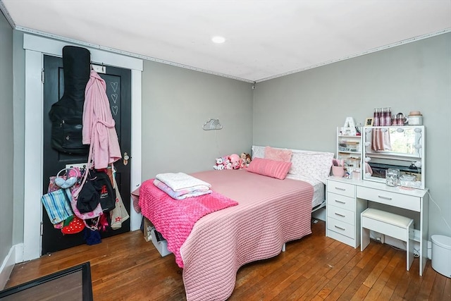 bedroom with dark hardwood / wood-style flooring