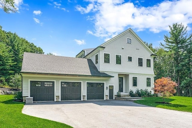 front facade with a garage and a front yard